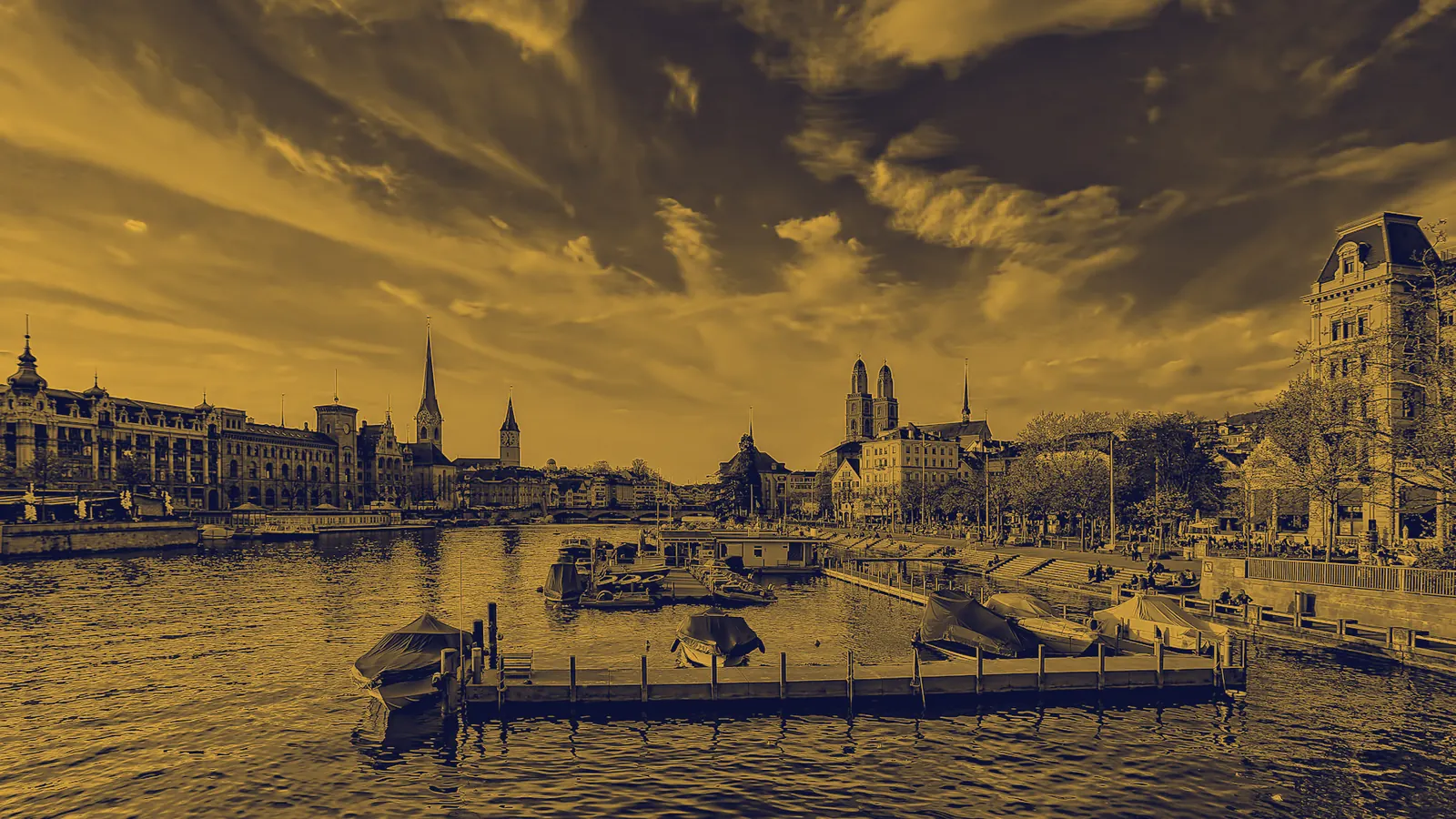 Gold-on-ink duotone photograph of Zürich’s old town and river, the host city of Interchange Zürich 2027.